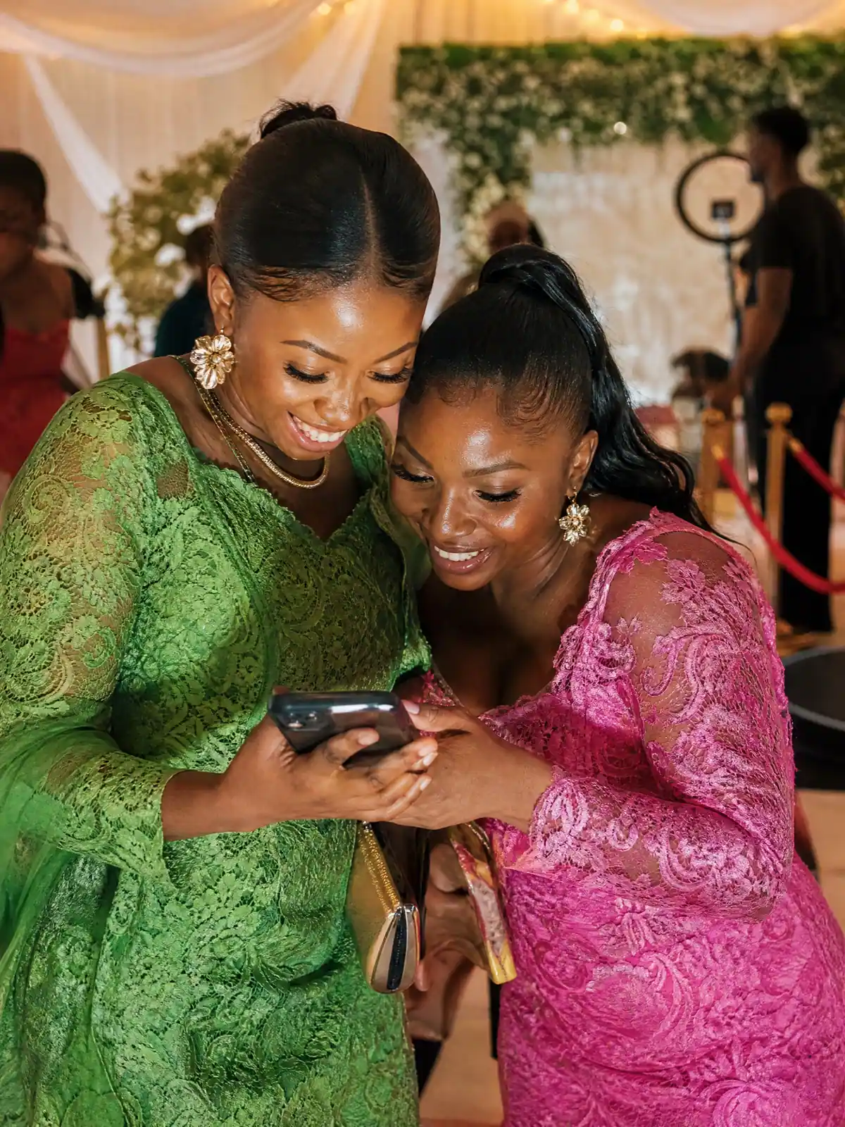Wedding guests watching their slow-motion 360 video on a phone after scanning the QR code